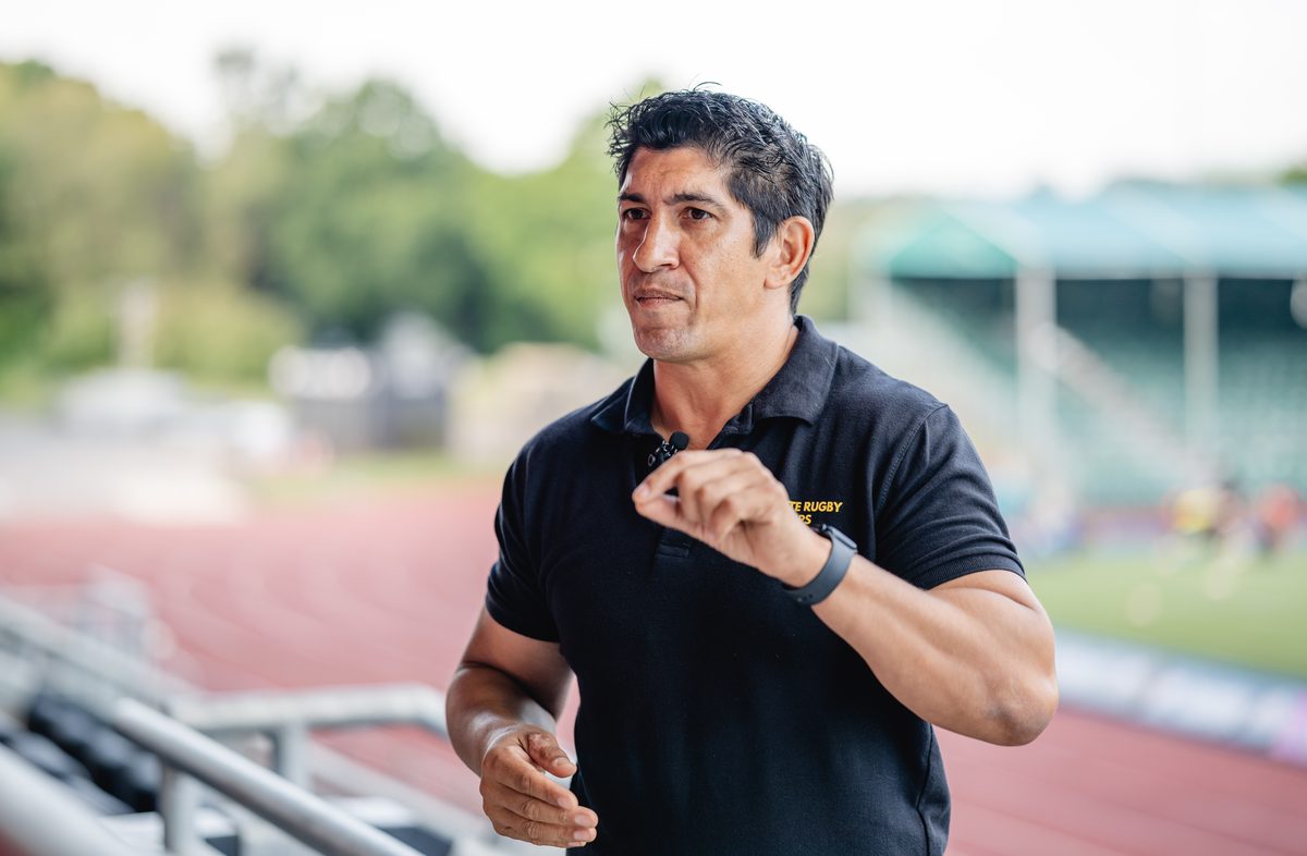 Nash Cohen coaching on the floodlit pitch